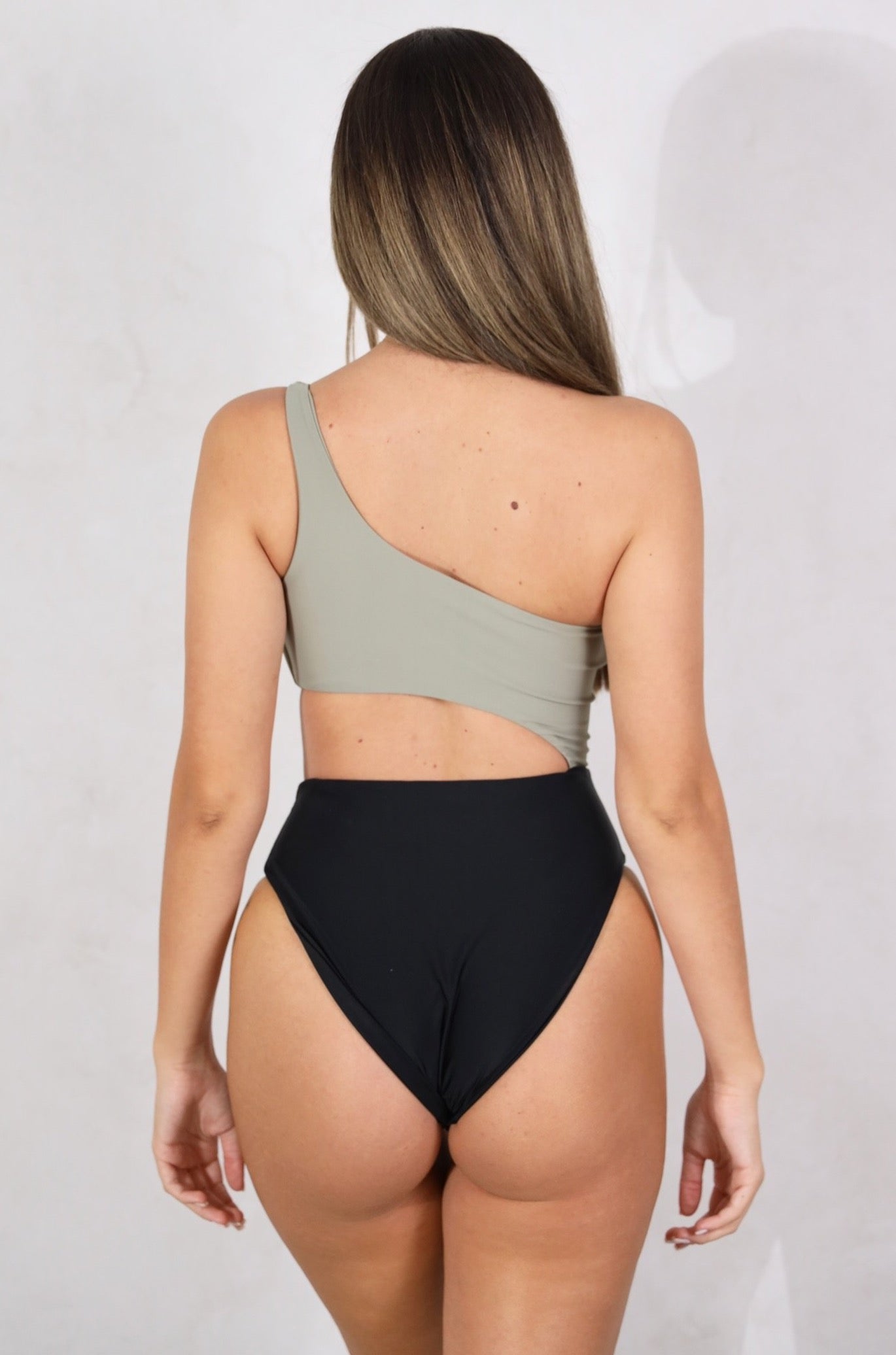 Shop our women's one piece, one shoulder strap swimsuit with a side open cut. Cheeky to medium coverage. Removable padding. Women's one piece swimsuits.High waist swimsuit. Women's Bikinis and swimsuits.Women's swimsuits. Khaki and Black bikinis & swimsuits. Khaki & Black Bathers. Multi colour swimsuit. Free Shipping on Australian Orders over $100. Free Shipping to New Zealand on orders over $180. Shipping Worldwide.