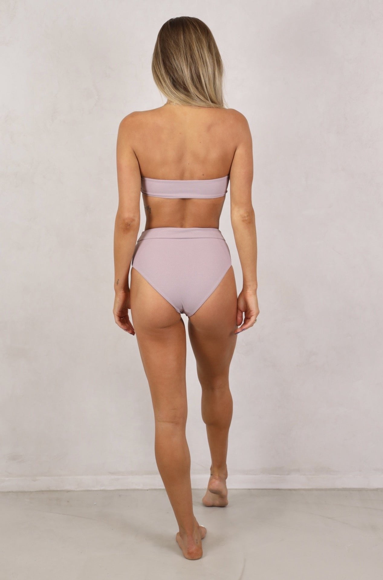 Shop women's high waist seamless ribbed swimwear.Shop Women's Swimwear online.Women's Bikinis and swimsuits. Lilac ribbed swimwear. High waist bikini bottoms. Full coverage. Lilac bikini bottoms. Free Shipping on any Australian Order over $100. Free Shipping to New Zealand on orders over $180. Afterpay Available. Fabric: Ribbed / Easy to care / Stretchy / 87% Nylon / 13% Spandex 