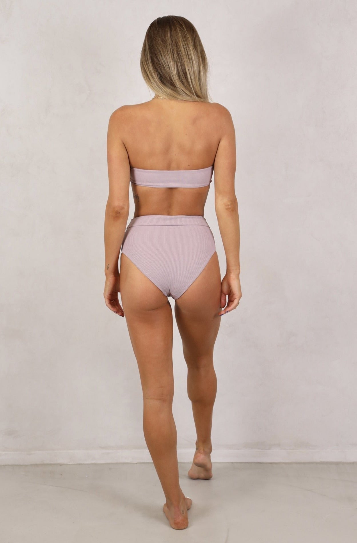 Shop ribbed strapless bandeau swimwear tops with removable front tie up knot. Women's Swimwear.Lilac bikinis.Lilac ribbed swimwear.Strapless Bandeau with removable padding. Women's Bikinis and swimsuits. High Waist full coverage bottoms.Free Shipping on Australian Orders over $100. Free Shipping to New Zealand on orders over $180. Shipping Worldwide.